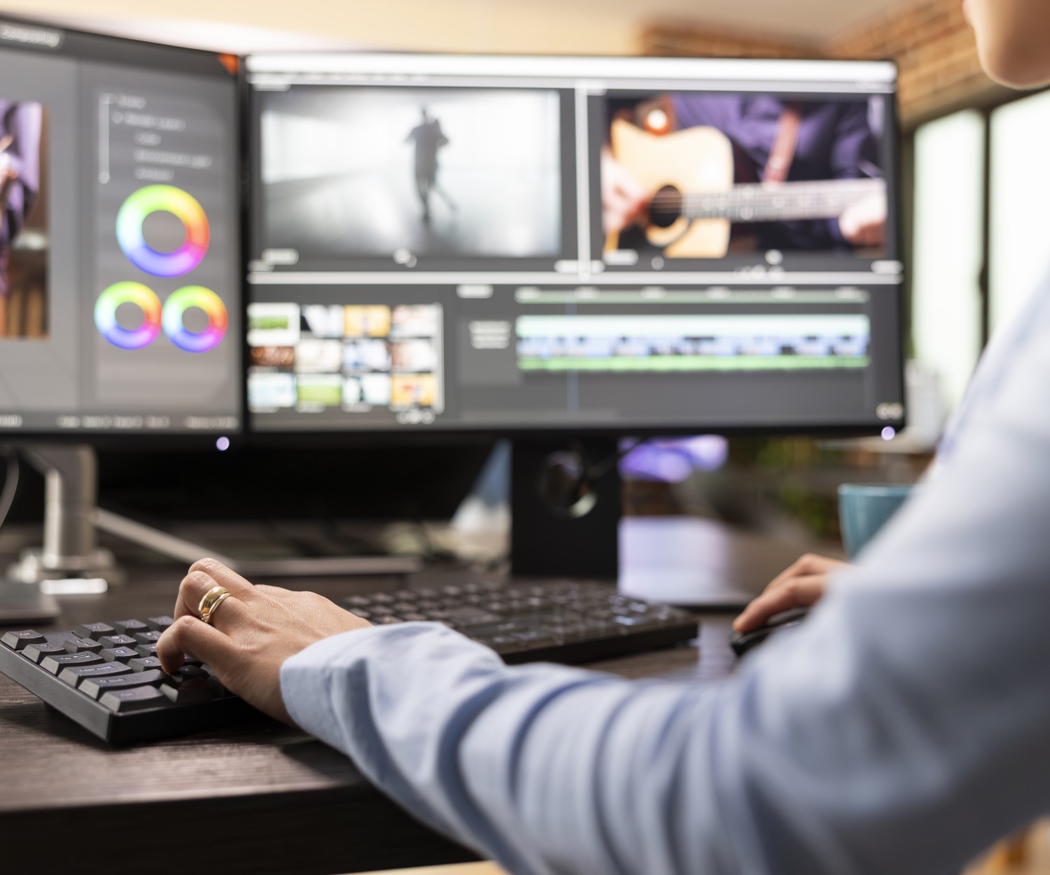 Closeup of video editor with hand on keyboard, using advanced software to refine movie footage. Professional filmmaker working with multi monitor, adjusting film frames to improve cinematic quality.